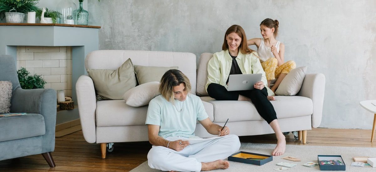 A family enjoying quality time together in a cozy living room setting, bonding and working.