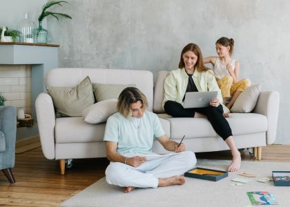 A family enjoying quality time together in a cozy living room setting, bonding and working.